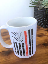 distressed red line and black flag coffee cup on a wood table